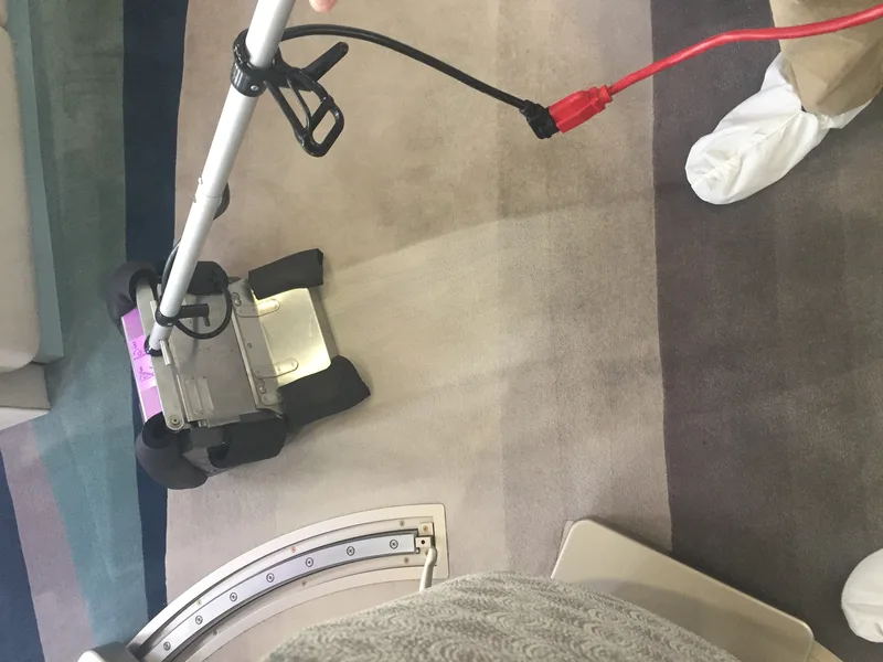 Low moisture extraction across a gray aircraft cabin carpet during an on wing cleaning