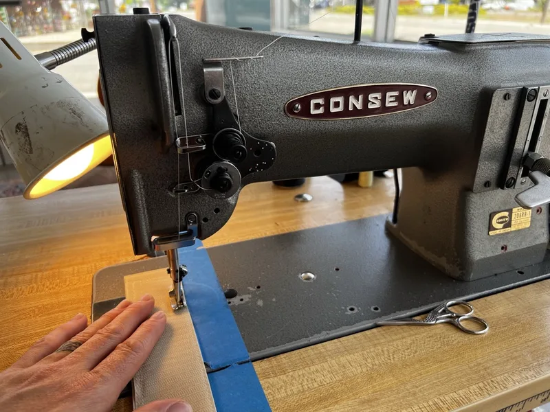 An aircraft carpet edge being serged on the Consew machine at the Fiber Specialties shop