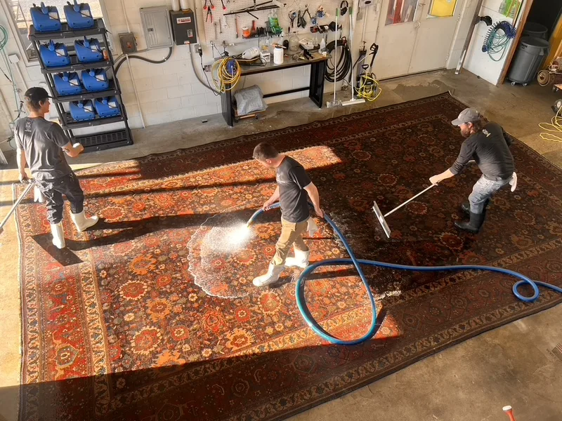 The circa 1890 Bijar rug during its full-immersion wash on the Fiber Specialties wash floor