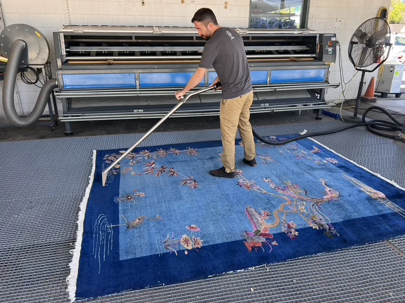 A blue Chinese rug part way through a full-immersion wash at the Fiber Specialties Boise facility
