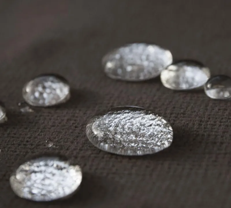 Water drops beading on a dark Fiber ProTector treated upholstery fabric
