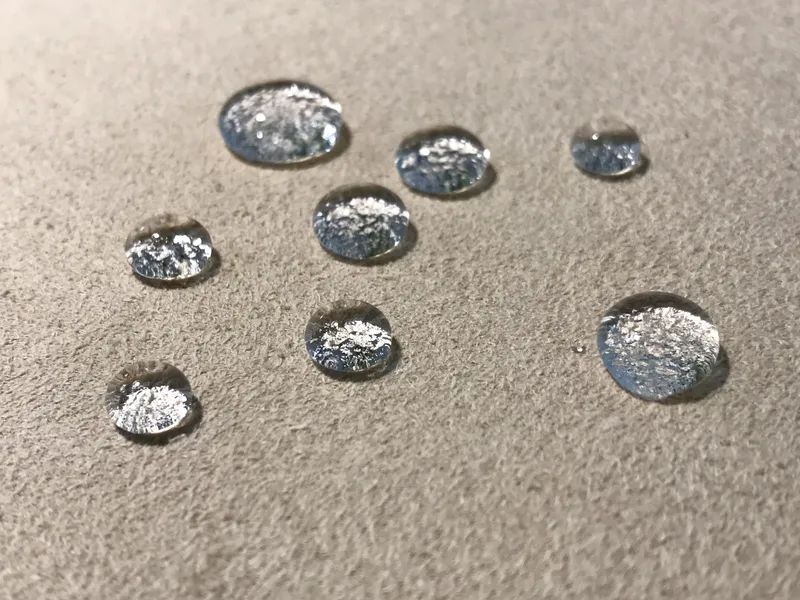 Water beading on the surface of a Fiber ProTector treated gray cabin textile