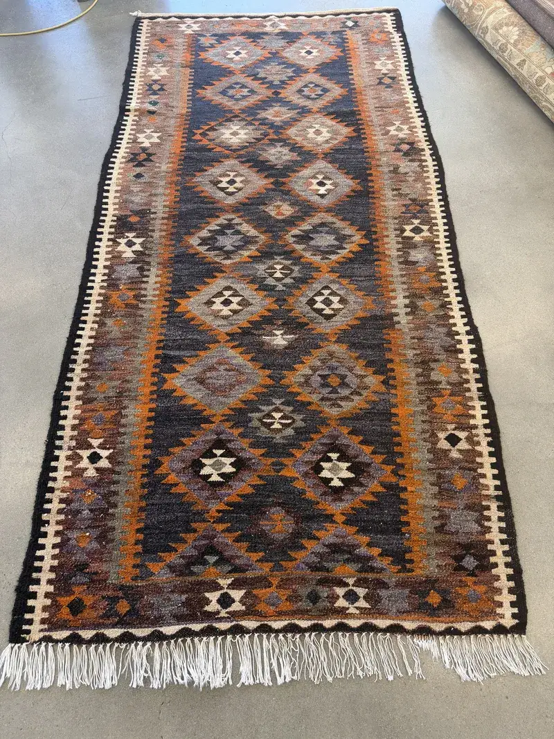 A flatwoven wool kilim runner with diamond medallions at the Fiber Specialties Boise shop