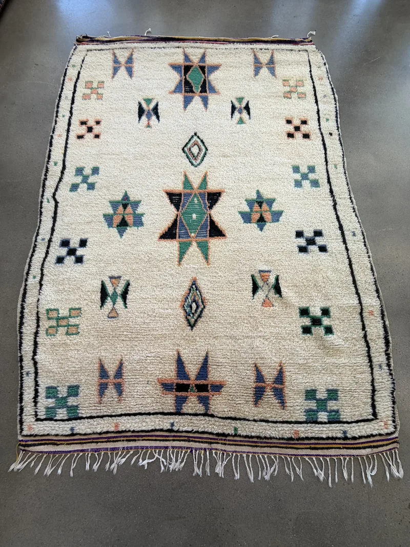 A vintage Moroccan Berber rug with diamond motifs at the Fiber Specialties Boise shop