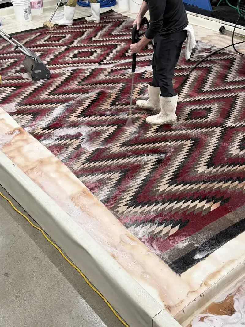 A red and black chevron Navajo weaving during washing at the Fiber Specialties Boise facility