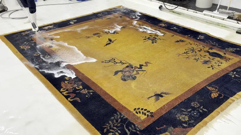 A gold Nichols Chinese Art Deco rug during its full-immersion wash at the Fiber Specialties Boise facility