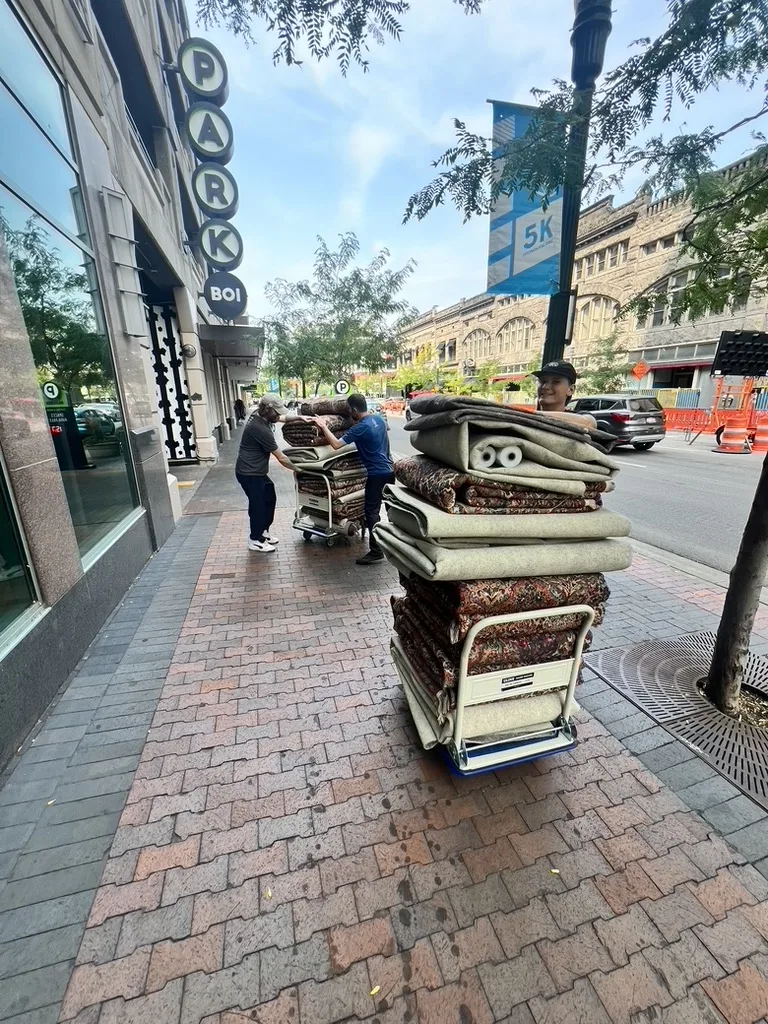 Rolled rugs on a cart during a downtown Boise pickup by the Fiber Specialties team