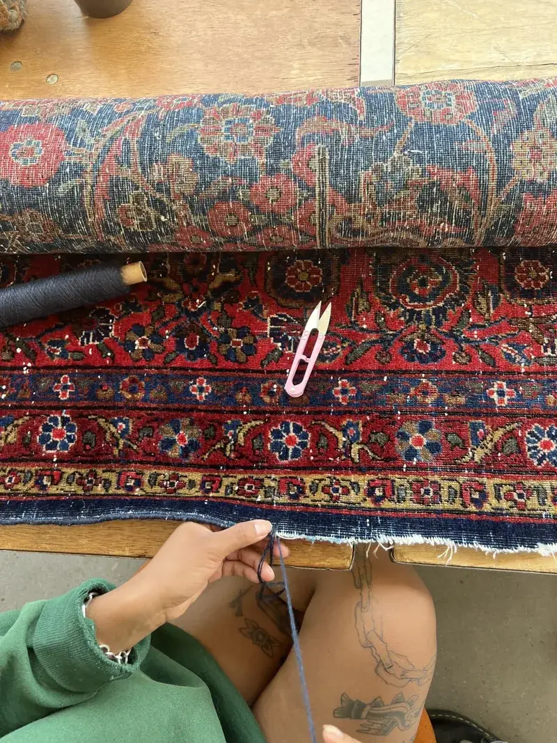 Whip-stitch edge repair on the back of a hand-knotted rug