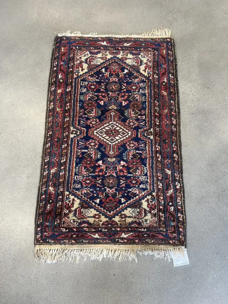A Persian rug after full-immersion cleaning, laid out for inspection