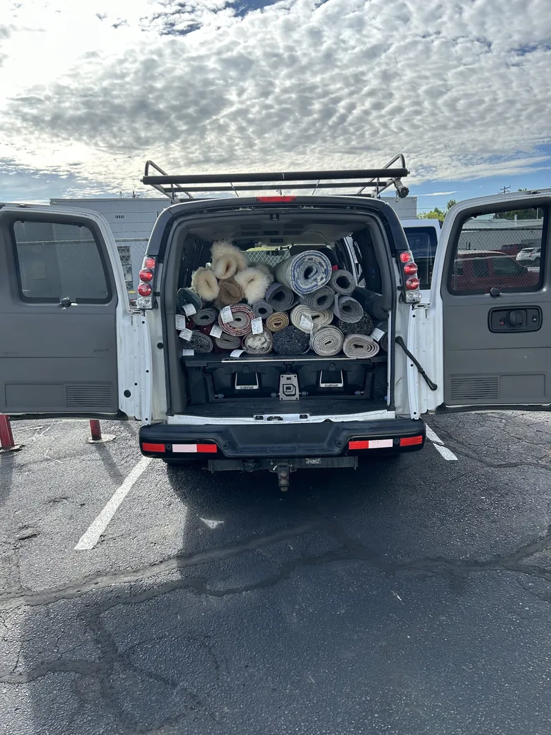 The Fiber Specialties van loaded with rolled rugs collected from customers across the Treasure Valley