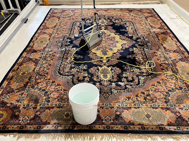 A large Kerman rug laid out on the wash floor at the Fiber Specialties Boise facility