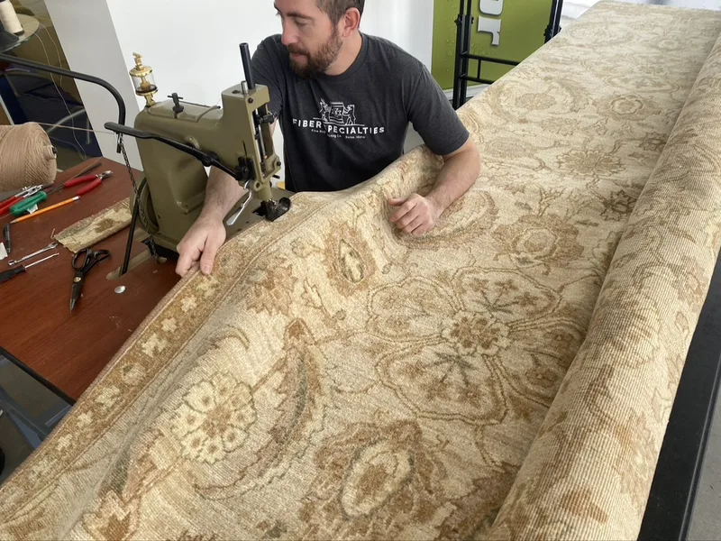A resized rug getting its new edge serged at the Fiber Specialties Boise shop