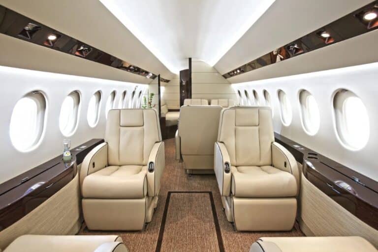 Luxurious interior of a private jet featuring plush leather seats arranged for comfort and elegance.