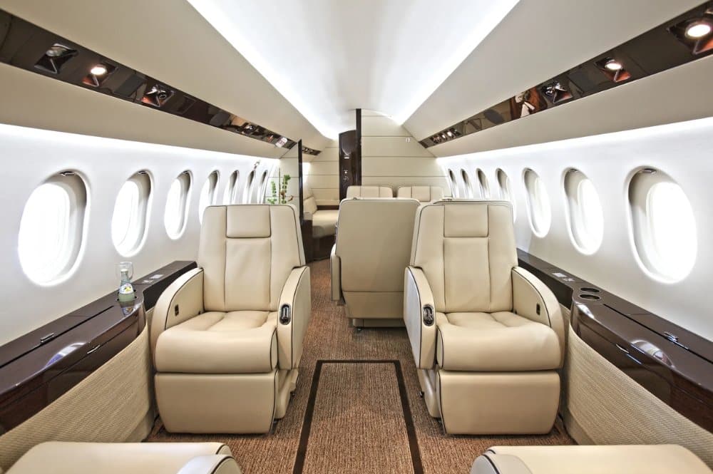 Luxurious interior of a private jet featuring plush leather seats arranged for comfort and elegance.