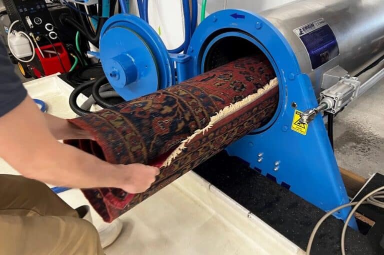 A man operates a machine to effectively clean a rug, demonstrating the process of carpet maintenance and care.