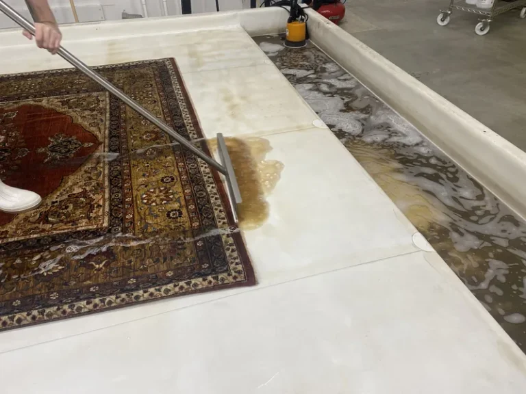Dirty wash water squeegeed out of a rug during a full-immersion wash at the Fiber Specialties Boise facility