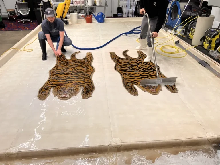 Two tiger pattern wool rugs side by side during washing at the Fiber Specialties Boise facility